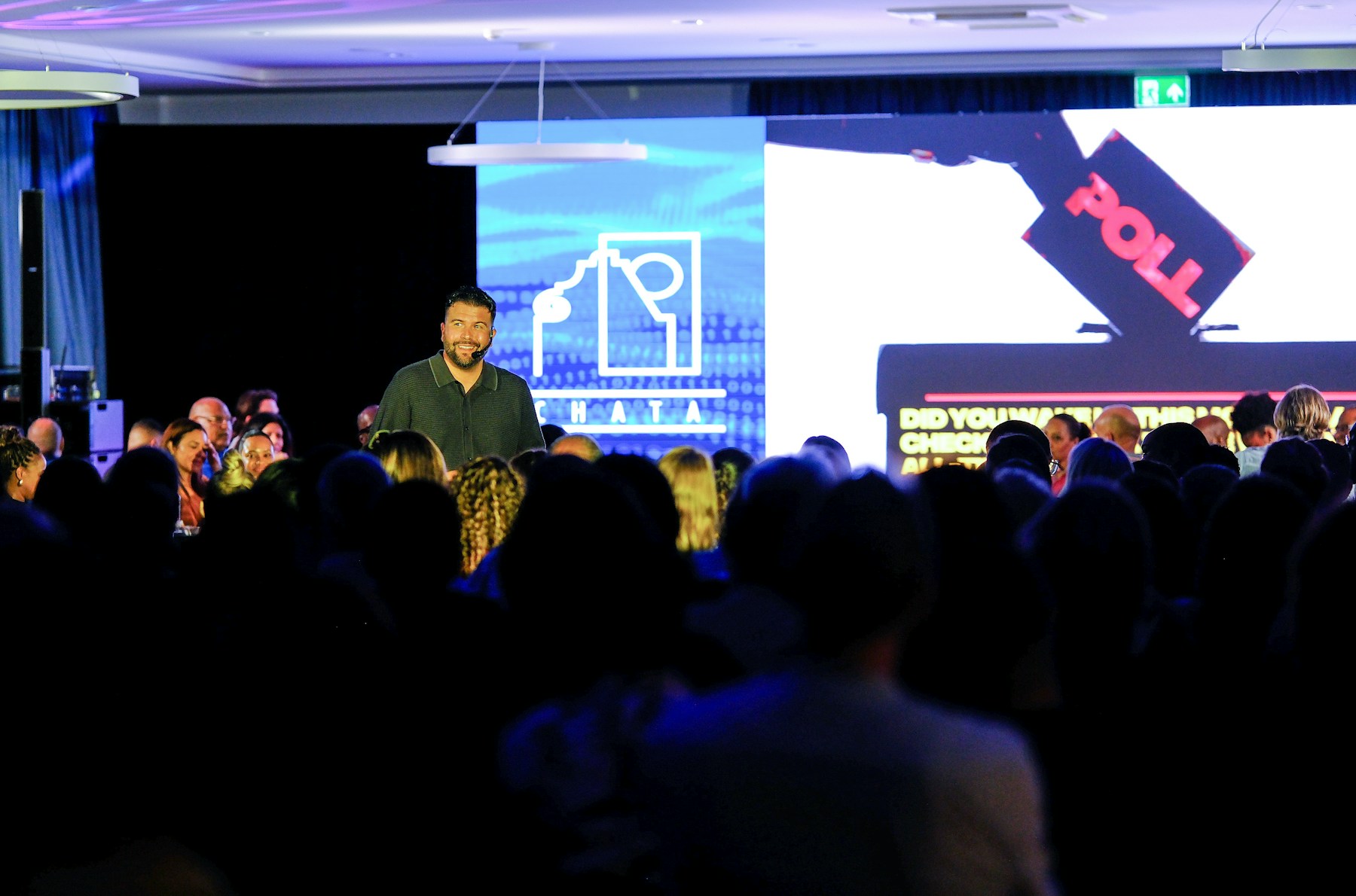 Speaker presenting on stage at a conference